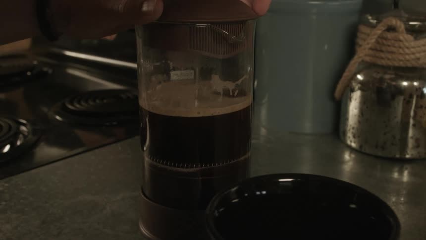A container filled with liquid being pressed
