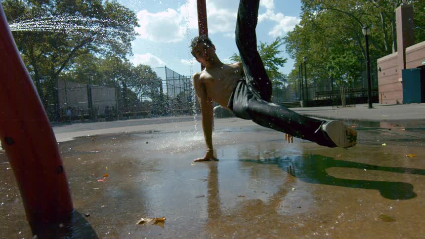 A man break dancing in a puddle