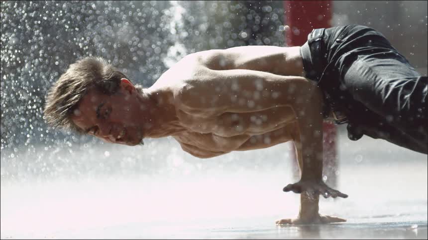 Man break dancing under pouring water