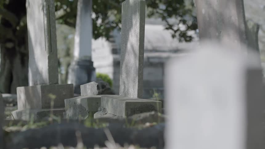 Cemetery view of some tombstones on a sunny day