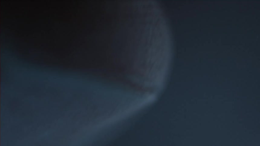 A macro shot of the tip of someone's finger and fingernail