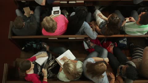 People sitting in pews all talking together
