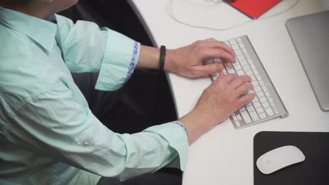 A person typing on a keyboard