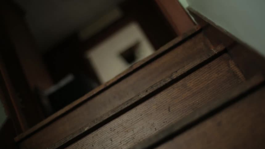 An eerie footage of a stair on an empty house