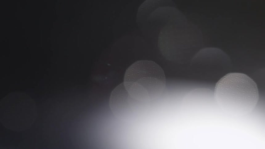 Dark area with small bits of blurry light