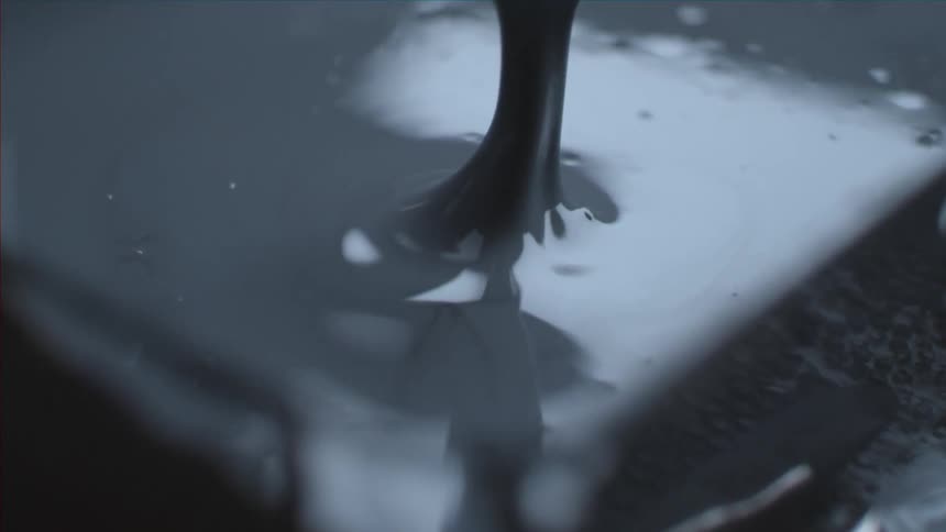 Paint being poured into a pan