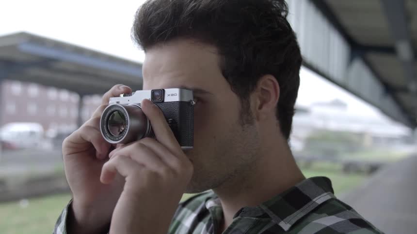 A man is taking pictures in the city