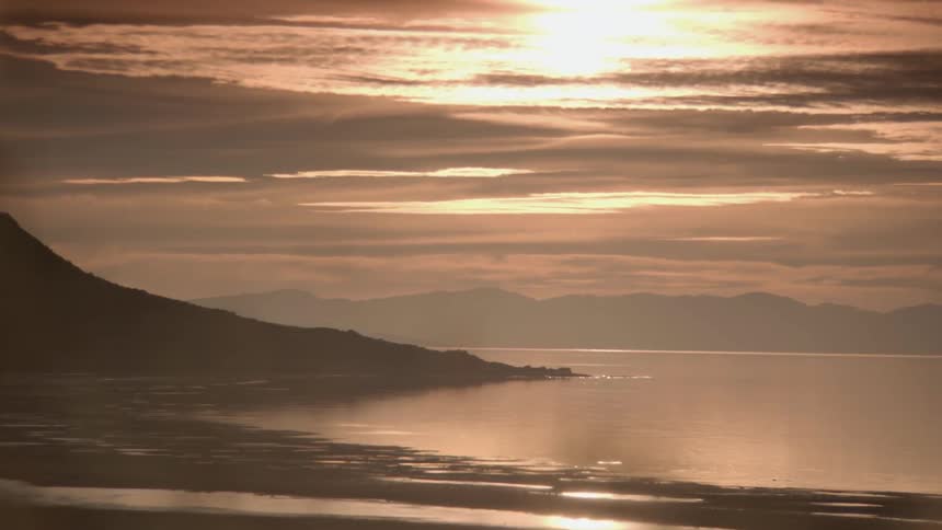 Clouds drift over a body of water