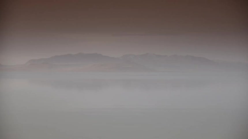 Heavy fog sets over a mountain range