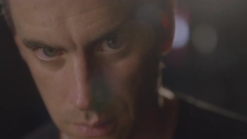 A man stares intently and then looks up