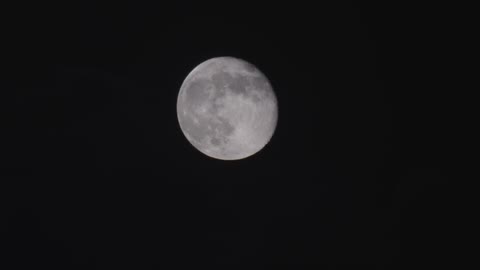 Clouds pass in front of the moon