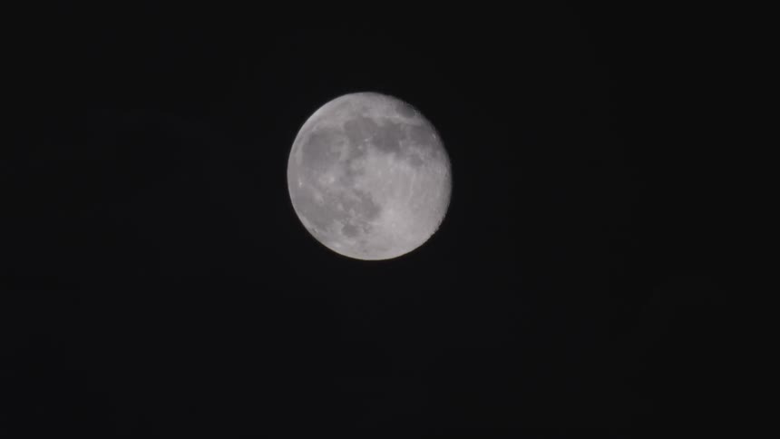 Clouds pass in front of the moon