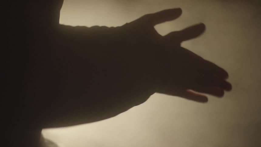 Man heats his hands up in front of an open fire