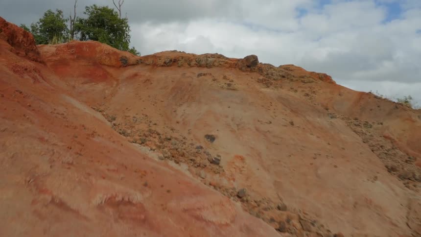 First person view of mountain terrain leading up to an edge where mountains and valleys are seen