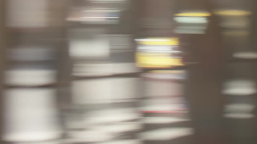 A blurry yellow car driving past