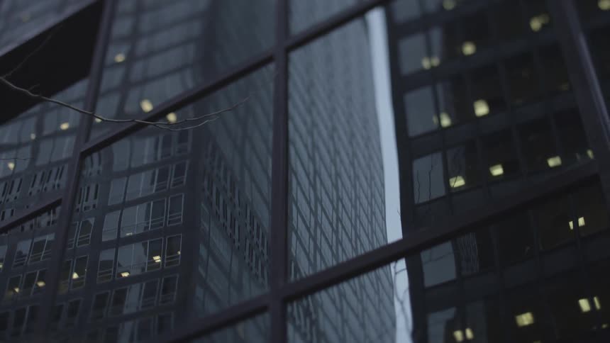 Reflection of tall skyscrapers on the windows of another building