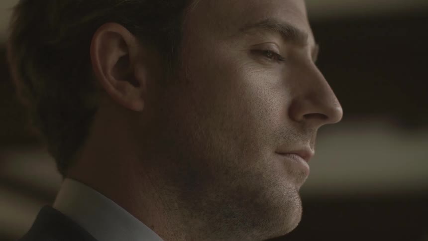 A close up view of a man face drink a cup of coffee