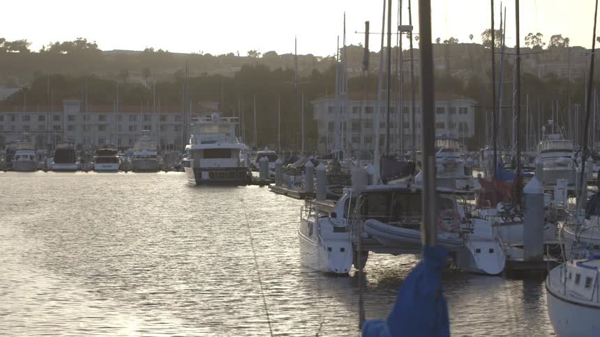 Boats parked at a harbor with flowing water
