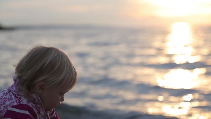 A kid walking on the beach