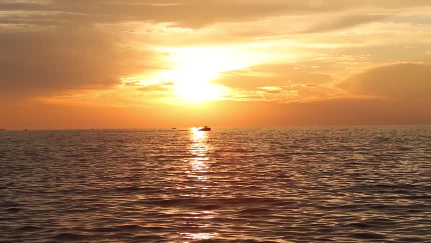 A ship on the ocean at sunset