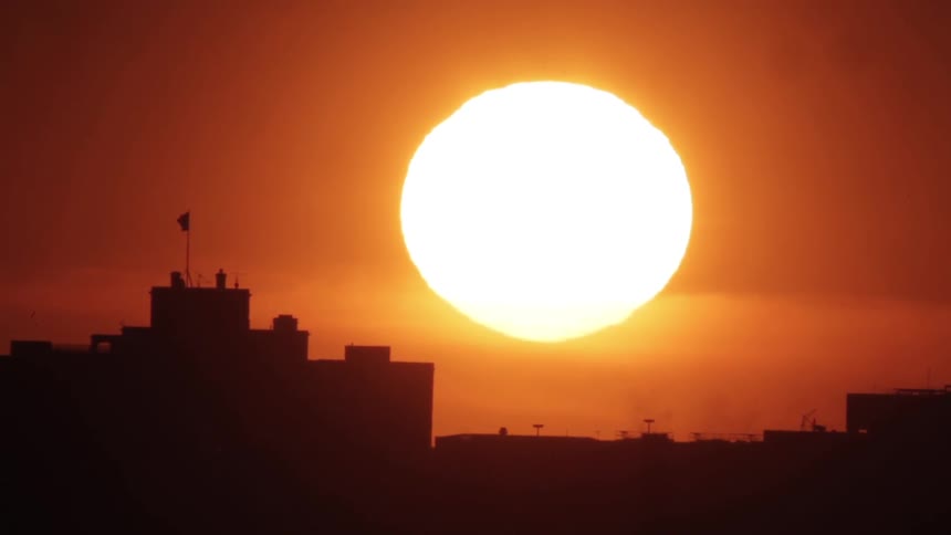 The sun is seen in the evening sky