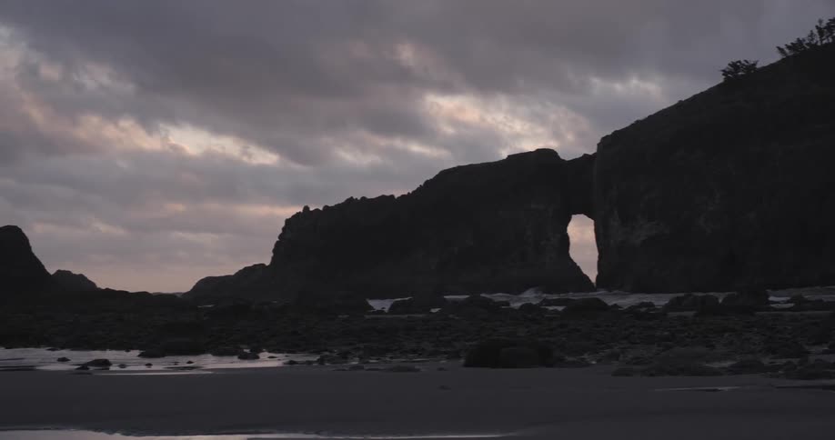 Waves crashing on the beach on a cloudy day
