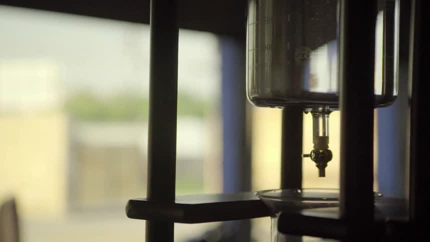 A person walks by a yama cold brew dripper