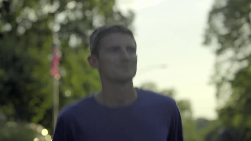 Man jogs down the road on a sunny morning