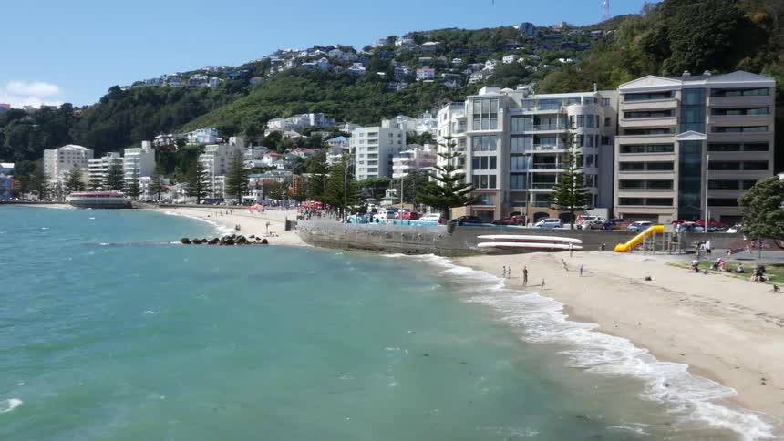Buildings border a sandy beach