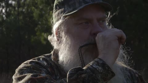 A man's beard is blowing in the breeze