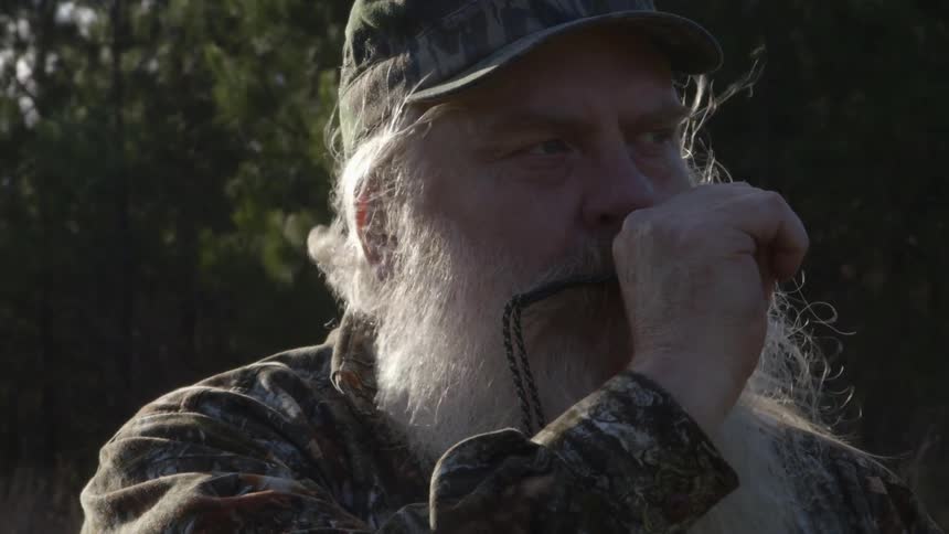 A man's beard is blowing in the breeze