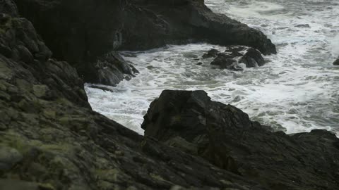 Waves beat against a rocky beach