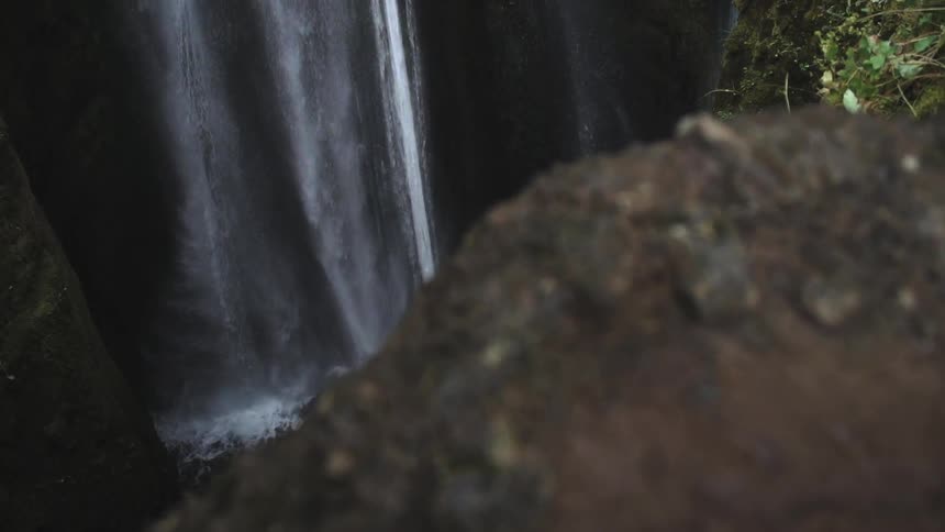 Very tall waterfalls send water crashing into the lagoon below