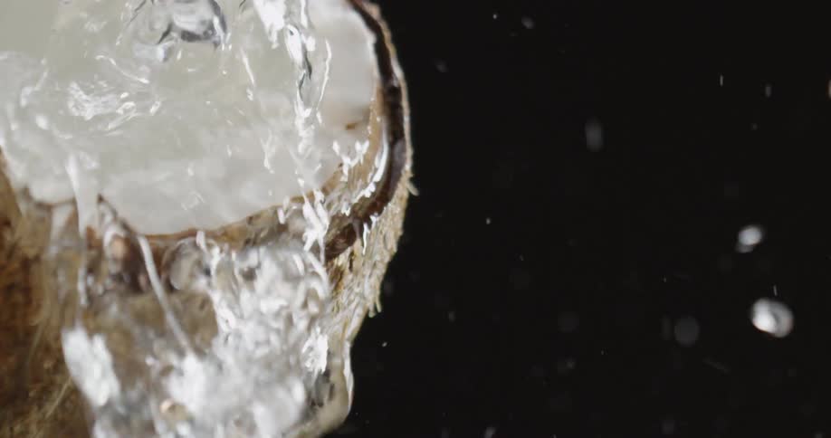 Water is spilling over a cracked coconut shell