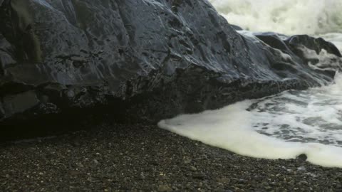 Waves crash on a rocky beach