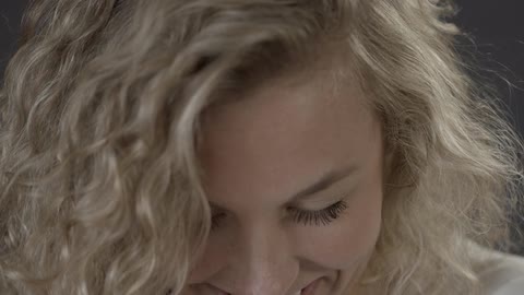 A woman smiles and laughs