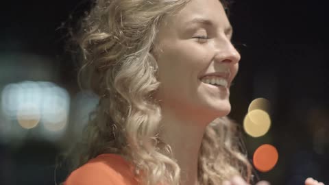A woman smiles and laughs