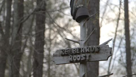 A sign posted on a tree in the woods