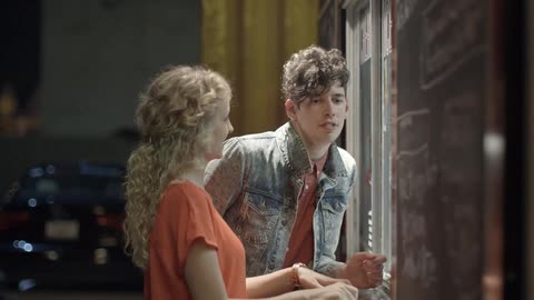 A couple is looking through a window