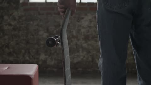A man picks up a skateboard