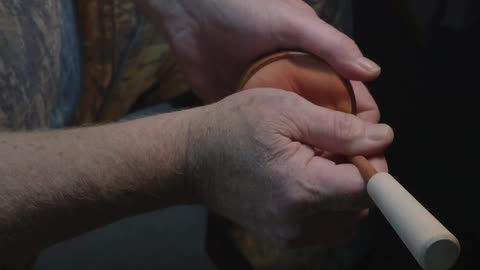 A man uses a tool with his hands
