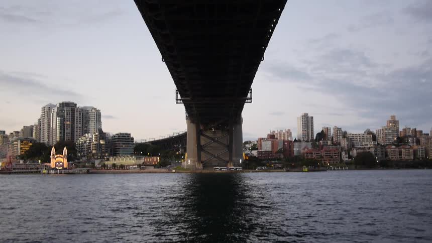 View from under a bridge of a lake, skyline, and the underside of the bridge