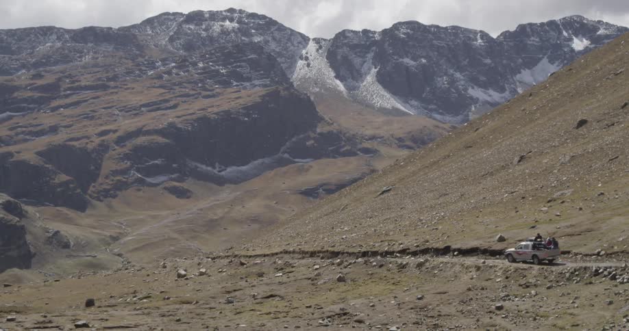 A vehicle travels down a mountain