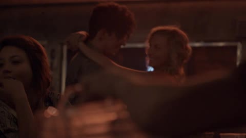A man and woman slow dance