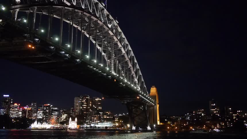 A bridge spans a body of water into a city