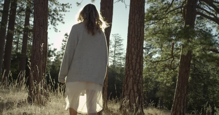 A young woman walking in the woods