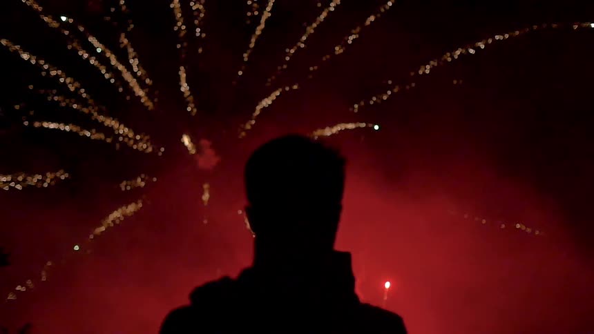A footage of a man seeing a fireworks festival