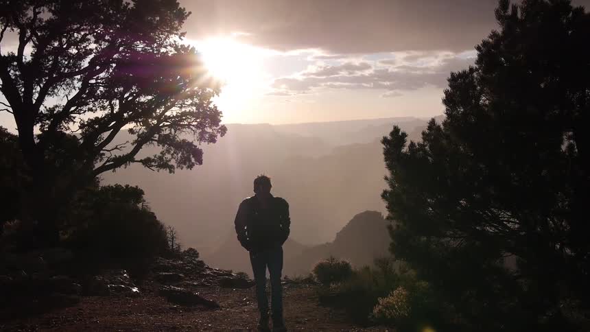 A man walking in the hill at dawn