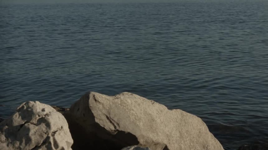 Water gently moves near rocks