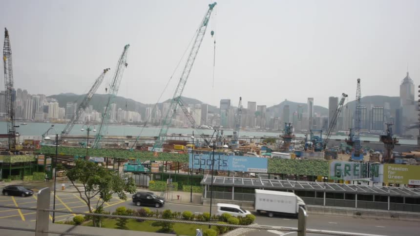 Cars driving by with the city in the background